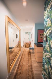 a hallway with a mirror and a hallway with rugs at Central Roomss in San Sebastián