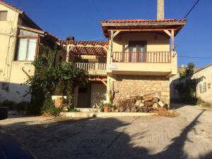 a house with a balcony on the side of it at Cosy Country Villa in Pappayiannádhes