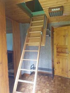 a staircase in a tiny house with a room at Lillastugan Sätuna in Falköping