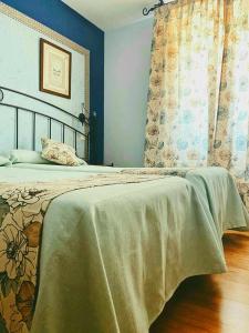 
a bedroom with a bed and a window at Posada Camino de Altamira in Santillana del Mar
