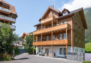 a large wooden building on the side of a road at Le Manoir Penthouse in Wengen