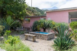 a backyard with a swimming pool and a house at Camping Villaggio Calanovella in Piraino