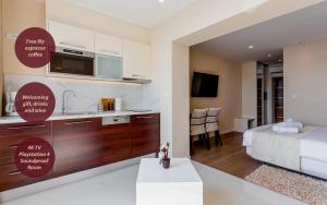a kitchen and a bedroom with a bed and a room with a kitchen at Villa Višnja in Brela