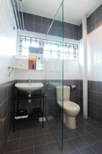 a bathroom with a toilet and a sink at The One Vacation Home in Melaka