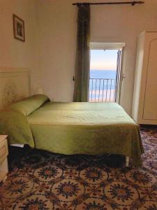 a bedroom with a bed with a view of the ocean at Rocca Sul Mare Hotel in Vieste