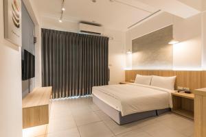 A bed or beds in a room at Shijo Inn