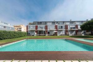 a large swimming pool in front of a building at Bruno's Beach House in Lavra