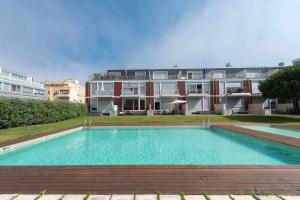 a large swimming pool in front of a building at Brunos Beach House in Lavra