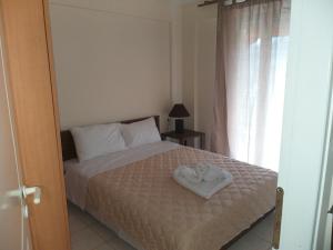 Ένα ή περισσότερα κρεβάτια σε δωμάτιο στο Ostria Seaside Apartments