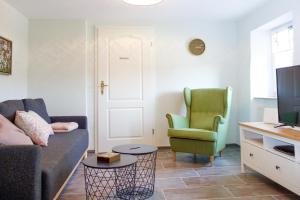 a living room with a couch and a chair at Das Kartenhaus in Saarburg