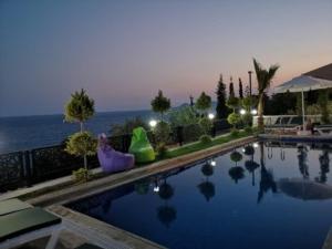 a swimming pool with a view of the ocean at Villa Noble in Demre