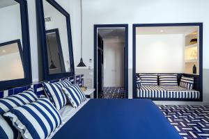 a blue bed with blue and white pillows in a room at Maison Il Conservatorio in Sorrento