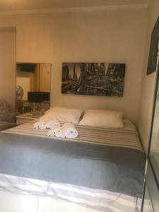 a bedroom with a bed and a painting on the wall at Miguel Torga Room in Coimbra