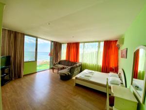 a bedroom with a bed and a room with a view of the ocean at Villa Jackie in Golden Sands +93 photos