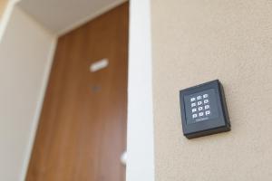 a remote control on a wall next to a door at Venezia Fly Apartments in Tessera