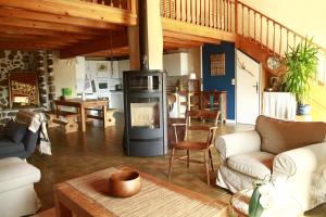 a living room with a fireplace in the center at Le Nid des Combes in Dunières-sur-Eyrieux