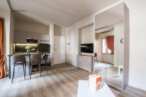 a kitchen and living room with a table and chairs at Carlina Palace by Varental in Turin