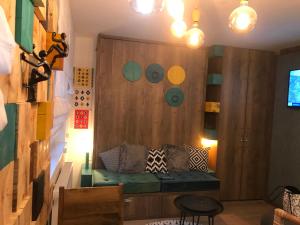 a living room with a couch in a wooden wall at Olimpijska kuca Jahorina - Apartman A708 in Jahorina