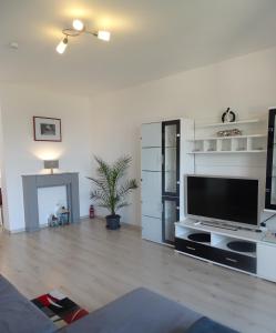 a living room with a large flat screen tv at Ferienwohnung Siesta in Bad Harzburg