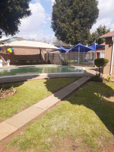 a swimming pool in the yard of a house at Hazelonz Bed &Breakfast in Pretoria
