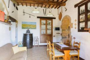 a living room with a table and a dining room at Girasole Cottage overlooking the Orcia valley in Tuscany in Radicofani