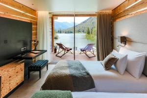 a bedroom with a bed and a large window at Au Club Alpin in Champex