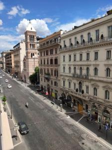 a city street with buildings and a clock tower at Hotel Miami in Rome