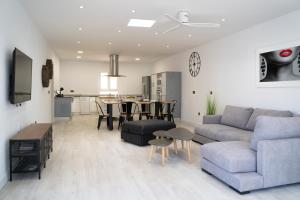 a living room with a couch and a table at Villa Ohana in Roquetas de Mar