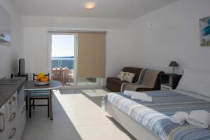 a bedroom with a bed and a living room at Apartments Medvidovic in Baška Voda