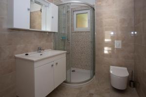 a bathroom with a sink and a shower and a toilet at Apartments Medvidovic in Baška Voda +29 photos
