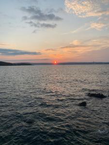 a sunset over a large body of water at Plaza suite 61 B in Bangor