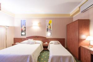 Postel nebo postele na pokoji v ubytování Boutique Hotel Puccini