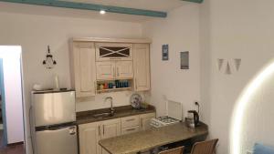 a kitchen with a refrigerator and a counter top at La Hacienda - Ras Sedr Chalet - Ras Sudr in Ras Sedr