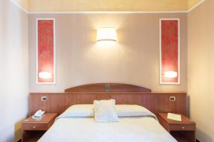 Postel nebo postele na pokoji v ubytování Boutique Hotel Puccini