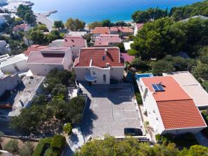 an aerial view of a house with the ocean in the background at Apartments Medvidovic in Baška Voda