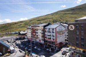 an overhead view of a city with buildings and a hill at Abelletes Apartments in Pas de la Casa