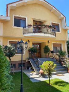 a building with a balcony with flowers on it at Alexia Rooms in Oradea