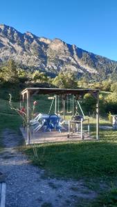 a park with a playground with a swing at Gite les Myosotis in Saint-Jean-Saint-Nicolas