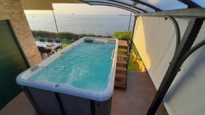 a hot tub on the balcony of a house at Relax vila žusterna in Koper