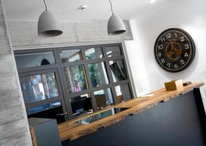 a large clock on a wall next to a window at Cavallestro Classic in Kitzingen