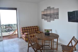 a living room with a couch and a table and chairs at BRILOC Appartement Route des îles Sanguinaires in Ajaccio