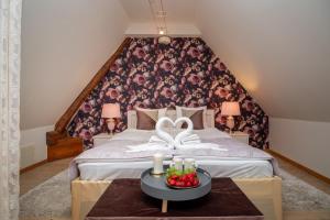 a bedroom with a large bed with a floral wall at Rataskaevu Boutique - 7 Unique Apartments in Tallinn
