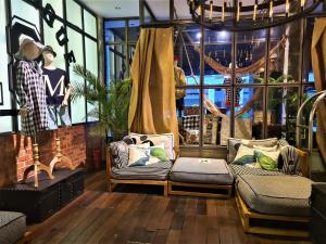 a room with two couches and a window at M Boutique Hotel Station 18 - Ipoh in Ipoh