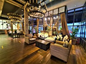 a living room with couches and a chandelier at M Boutique Hotel Station 18 - Ipoh in Ipoh