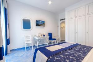 una camera con letto, tavolo e sedie di Hotel Metropole a Sorrento