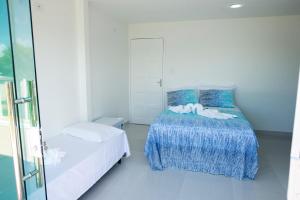 1 dormitorio con 2 camas y ventana en Pousada Porto Sol, en Porto de Galinhas