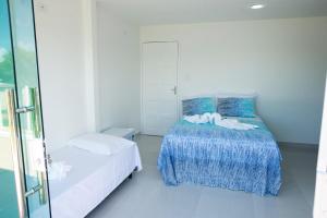 a bedroom with two beds and a window at Pousada Porto Sol in Porto De Galinhas