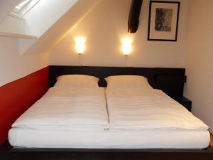 Postel nebo postele na pokoji v ubytování Suite „Hannover“ - modernes Apartment in Fachwerkhaus