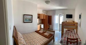a small living room with a couch and a kitchen at Jelić apartmani in Sutomore