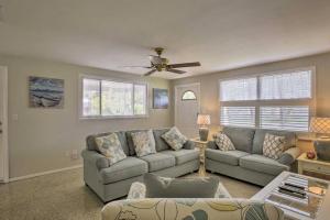 a living room with two couches and a ceiling fan at Rita's Cottage by the Beach - Steps to Ocean! in Clearwater Beach